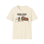 Beige t-shirt with a graphic of a police officer and fire truck and text 'Crime Scene. Not a Firehouse Driveway.'