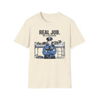 Beige t-shirt with a graphic of a police officer and text 'Real Job. Not a Sleepover.' on a white background.