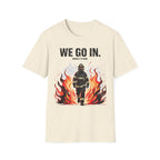 T-shirt with a firefighter graphic and text 'WE GO IN. WHEN IT'S BAD.' on a beige background